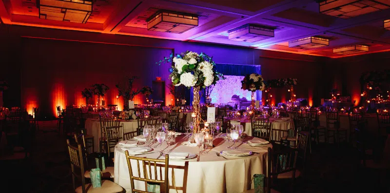 decorated-banquet-hall-with-served-round-table-with-hydrangea-centerpiece-chiavari-chairs-1